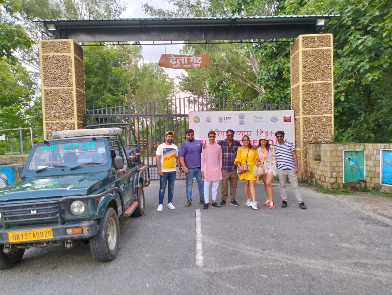 Visitors beside a safari jeep at Dhela Gate