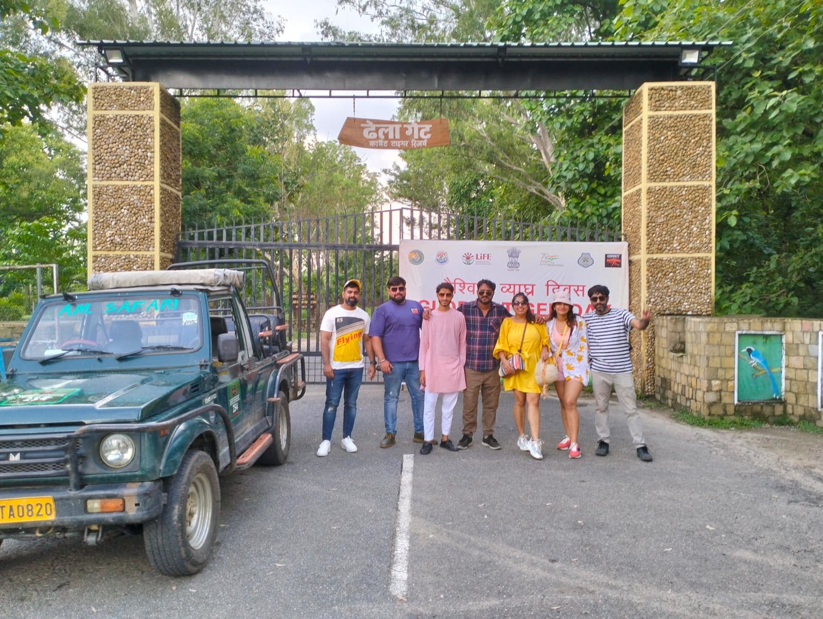 Travelling together — a group beside a safari jeep outside Dhela Gate
